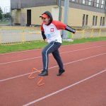 Uczestnik zawodów skacze przez płotek