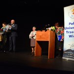 Przewodniczący Rady Powiatu w Policach Cezary Arciszewski i Członek Zarządu Powiatu w Policach Beata Chmielewska przekazują na scenie życzenia