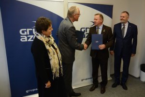 Starosta Policki Andrzej Bednarek i Prezes Grupy Azoty Polyolefins przekazują sobie umowę w obecności przedstawicieli Powiatu Polickiego i Grupy Azoty