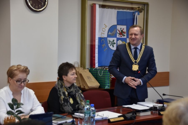 Obrady sesji Rady Powiatu w Policach, przy stole na stojąco Starosta Policki wygłasza krótkie przemówienie skierowane do przybyłych gości z Zachodniopomorskiej Izby Inżynierów Budownictwa, za stołem siedzą Wicestatrosta Policki oraz Członek Zarządu Powiatu w Policach