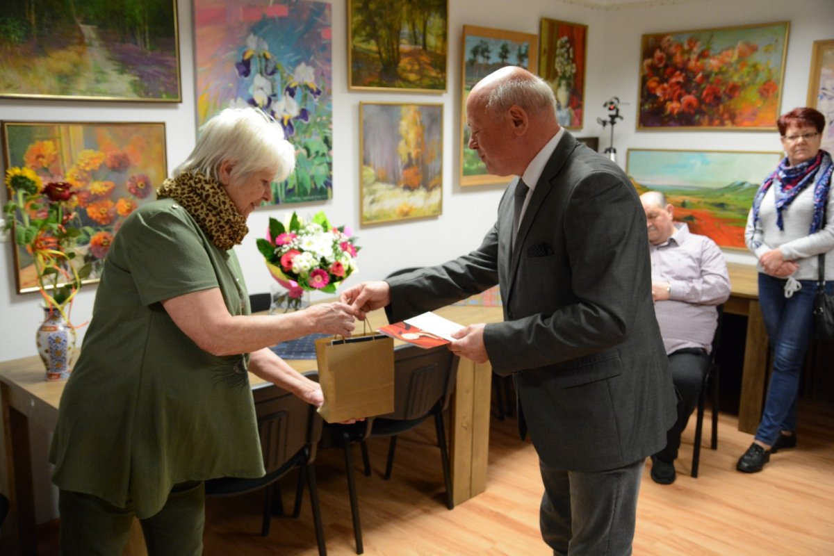 Cezary Arciszewski Przewodniczący Rady Powiatu wręcza upominek malarce