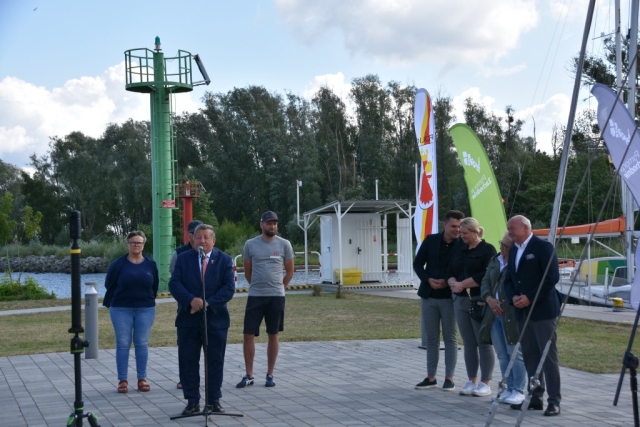 Moment przemówienia Burmistrza Polic podczas otwarcia regat, w tle pozostali uczestnicy wydarzenia.