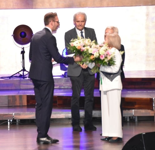 Mężczyzna wręcza bukiet kwiatów kobiecie