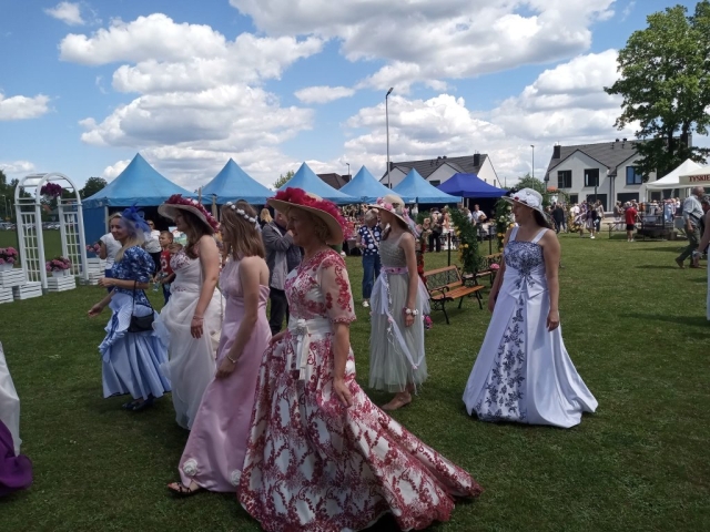 Kobiety w kolorowych sukienkach i kapeluszach