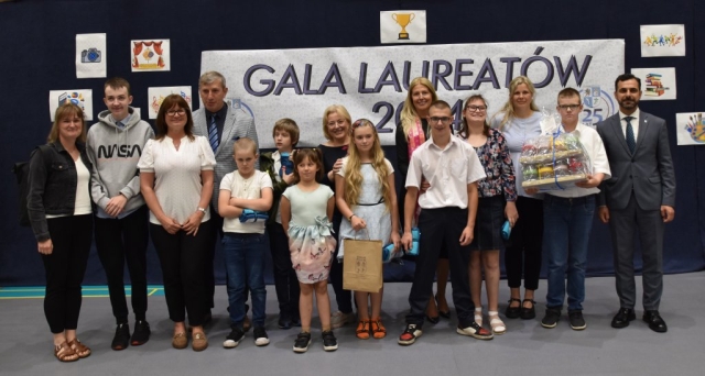 Przedstawiciele Powiatu Polickiego pozują do zdjęcia z nagrodzonymi uczniami