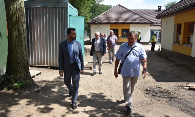 Goście przechodzą przez plac do innego budynku