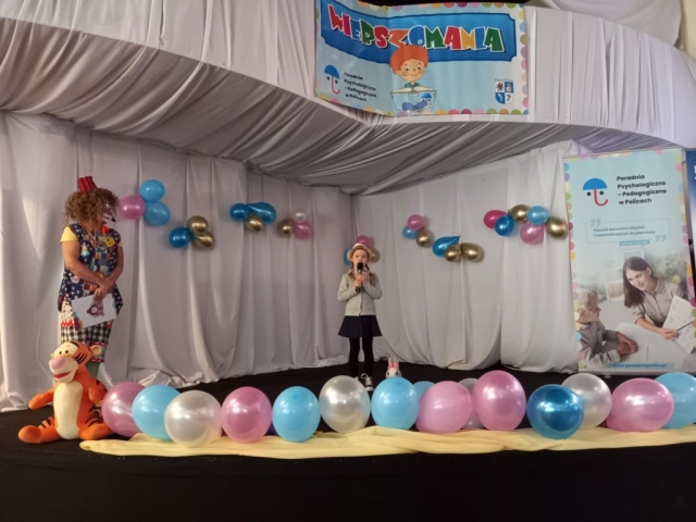 Występ dziewczynki recytującej wiersz na scenie